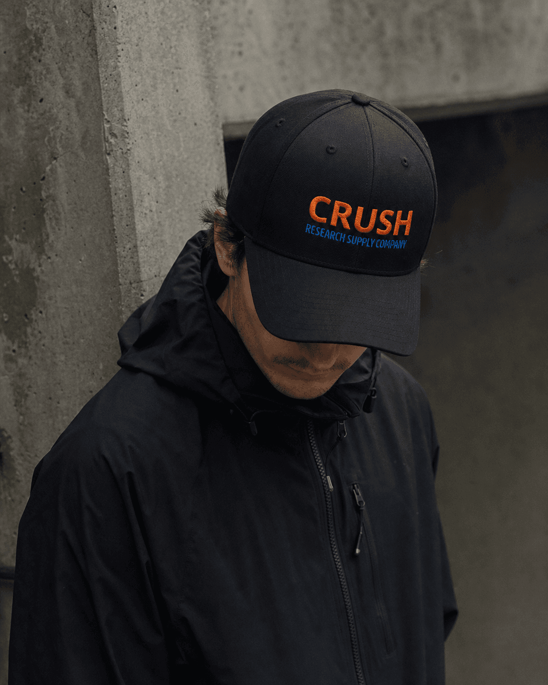 Model wearing the embroidered Crush Research Supply Company cap